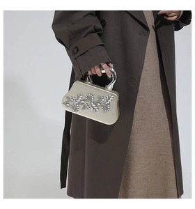 Detailed view of champagne rhinestone dinner clutch bag with floral gemstone patterns