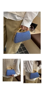 Detail of blue beaded evening bag with white faux pearls and gold chain strap