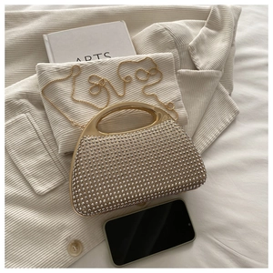 Detail of champagne gold frame evening clutch bag with sparkling silver rhinestones