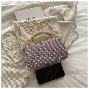 Detailed view of lavender rhinestone evening clutch with gold handle and chain strap