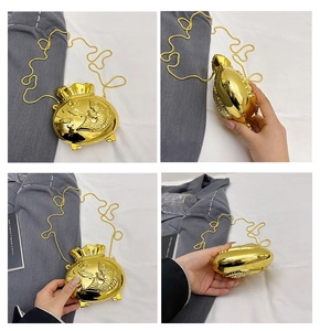 Detail view of golden fortune bag purse featuring lucky koi embossment and metal chain