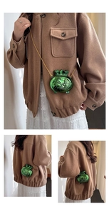Detail view of mini green lucky bag crossbody bag with fish pattern and gold chain strap