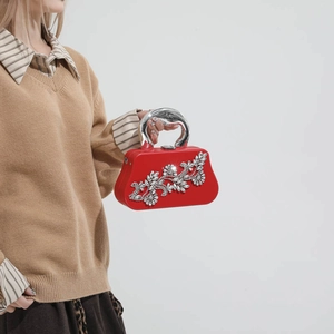 Red rhinestone evening clutch bag with silver circular handle for formal dinners
