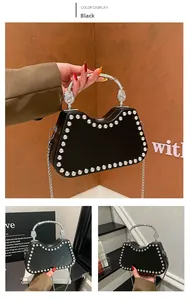 Detail of black box bag featuring silver stud trim, vintage handle and chain strap