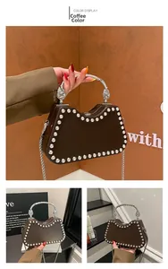 Detail of coffee brown hard shell evening bag with silver rhinestones and metal handle