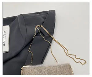 Detail of glitter handbag featuring a gold chain strap and studded metallic edges