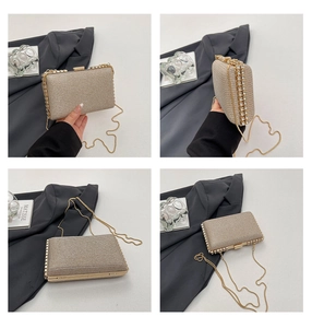 Detail of champagne gold sequin evening clutch bag with rhinestones and metal chain