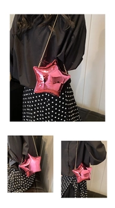 Detail of a bright pink star-shaped crossbody bag with a sleek gold chain strap