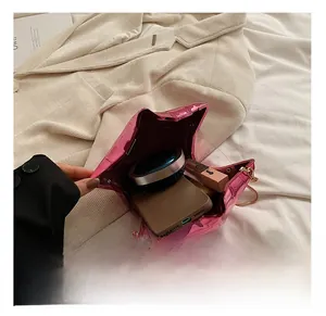 Star shaped metallic pink bag showing internal capacity for phone and cosmetics