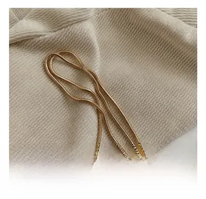 Close-up of elegant gold snake chain strap with smooth metallic texture and refined links