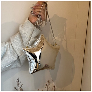 Close-up of a star-shaped silver mirror handbag with a delicate metal chain strap
