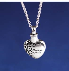 Macro detail of heart urn necklace with Always in my heart engraving and scroll pattern