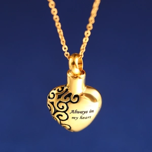 Golden heart cremation necklace with Always in my heart engraving on blue background
