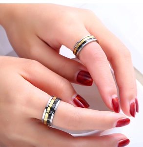 Close-up of tricolor rotatable stainless steel ring with Roman numeral engravings
