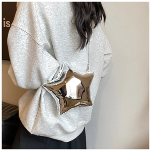 Close-up of a silver star-shaped evening bag with a metallic finish and chain strap
