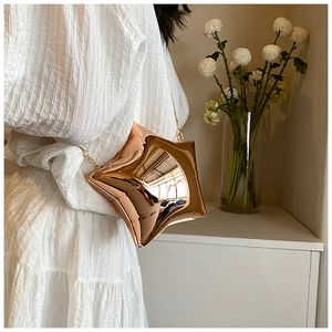 Close-up of star-shaped crossbody bag in metallic rose gold with chain strap