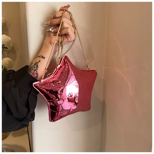Detailed side view of metallic pink star bag with gold snake chain and glossy finish