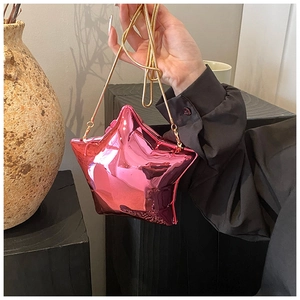 Detail of star-shaped crossbody bag with metallic pink mirror finish and gold chain