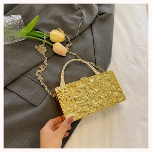 Golden evening clutch bag featuring textured pleats and a metallic chain handle