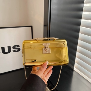 Golden acrylic box clutch with pearl handle and mirror finish for evening events