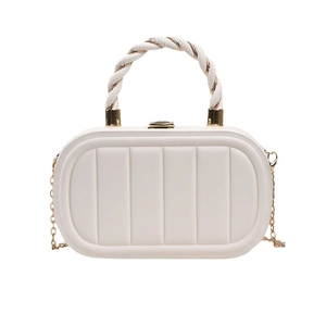 White quilted oval crossbody bag with gold chain strap and decorative twist handle