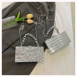Detail of silver box bags with metallic textures and elegant chain straps