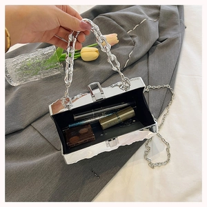 Silver mirror box bag with chain strap showing spacious interior for essentials