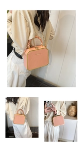 Pink octagonal hard box bag featuring gold trim and a detachable chain strap
