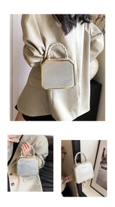 Detailed close-up of octagonal silver hard-shell handbag with gold metal trim and chain