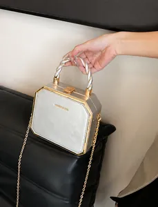 Detailed macro view of silver leather handbag texture with gold metal buckle and handle