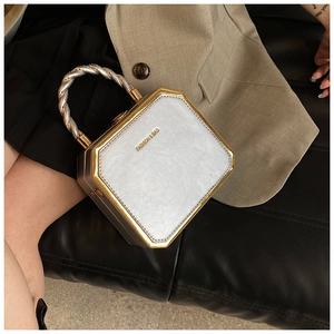 Detailed macro view of the octagon pearl silver handbag with twisted bicolor metal handle