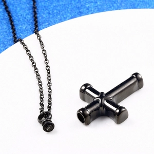Polished black stainless steel cross cremation pendant necklace for ashes on white tray