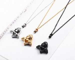 Detailed view of angel heart urn pendants in silver, gold, and black stainless steel finish