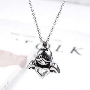 Close-up of angel girl pendant with wings and heart for ash memorial necklace