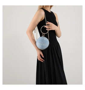 Detail of light blue glitter sphere evening bag with rhinestone handle and chain strap