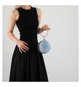 Detailed view of spherical light blue starry evening bag with sparkling stone handle