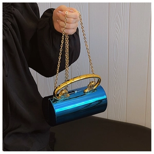 Detail of blue metallic cylindrical clutch with golden lion head handle and chain strap