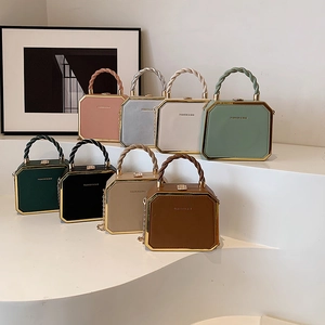 Octagonal crossbody bag in eight colors with woven handle and gold metal frame