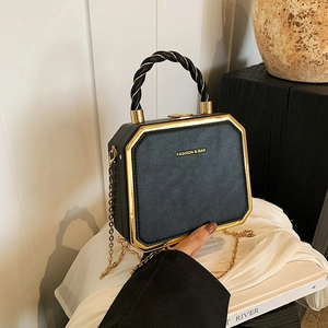 Classic black leather box handbag with gold metal trim and woven handle, elegant crossbody bag