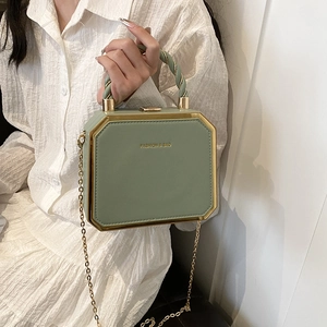 Elegant solid green box bag with gold metal frame and twisted handle for women