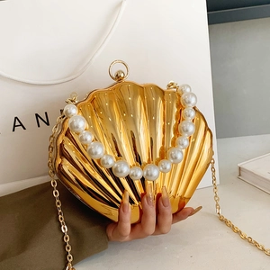 Elegant gold shell evening bag with pearl handle and metal chain for women