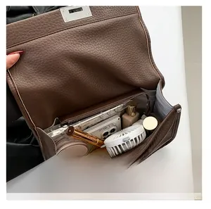 Interior view of leather messenger bag showing spacious storage for daily essentials