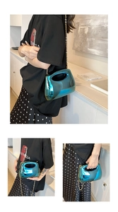 Detail view of electroplated blue acrylic evening clutch with gold chain strap for women
