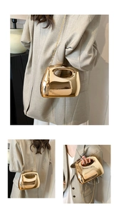 Macro detail of the golden mirror acrylic handbag with polished finish and metal chain