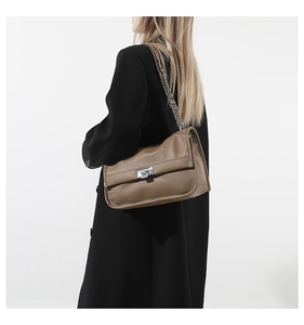 Brown lychee grain leather messenger bag detail showing silver buckle and chain strap