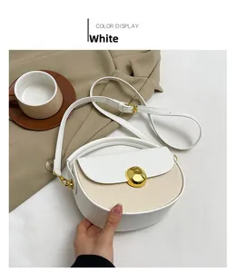 Detailed view of white semicircular crossbody bag with woven texture and gold clasp