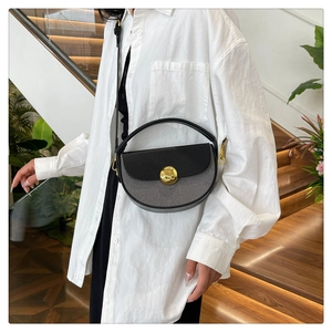Detail view of a semi-circular crossbody bag with a gold buckle and striped pattern design