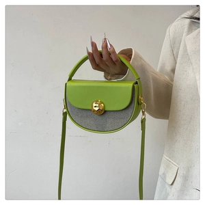 Detail of lime green half-moon handbag with gold buckle and grey textured fabric