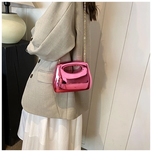 Metallic magenta acrylic handbag featuring polished finish and gold chain shoulder strap