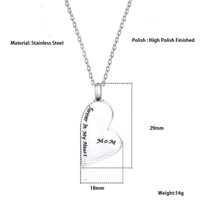 Detailed view of polished stainless steel heart pendant with Mom engraving and reflection